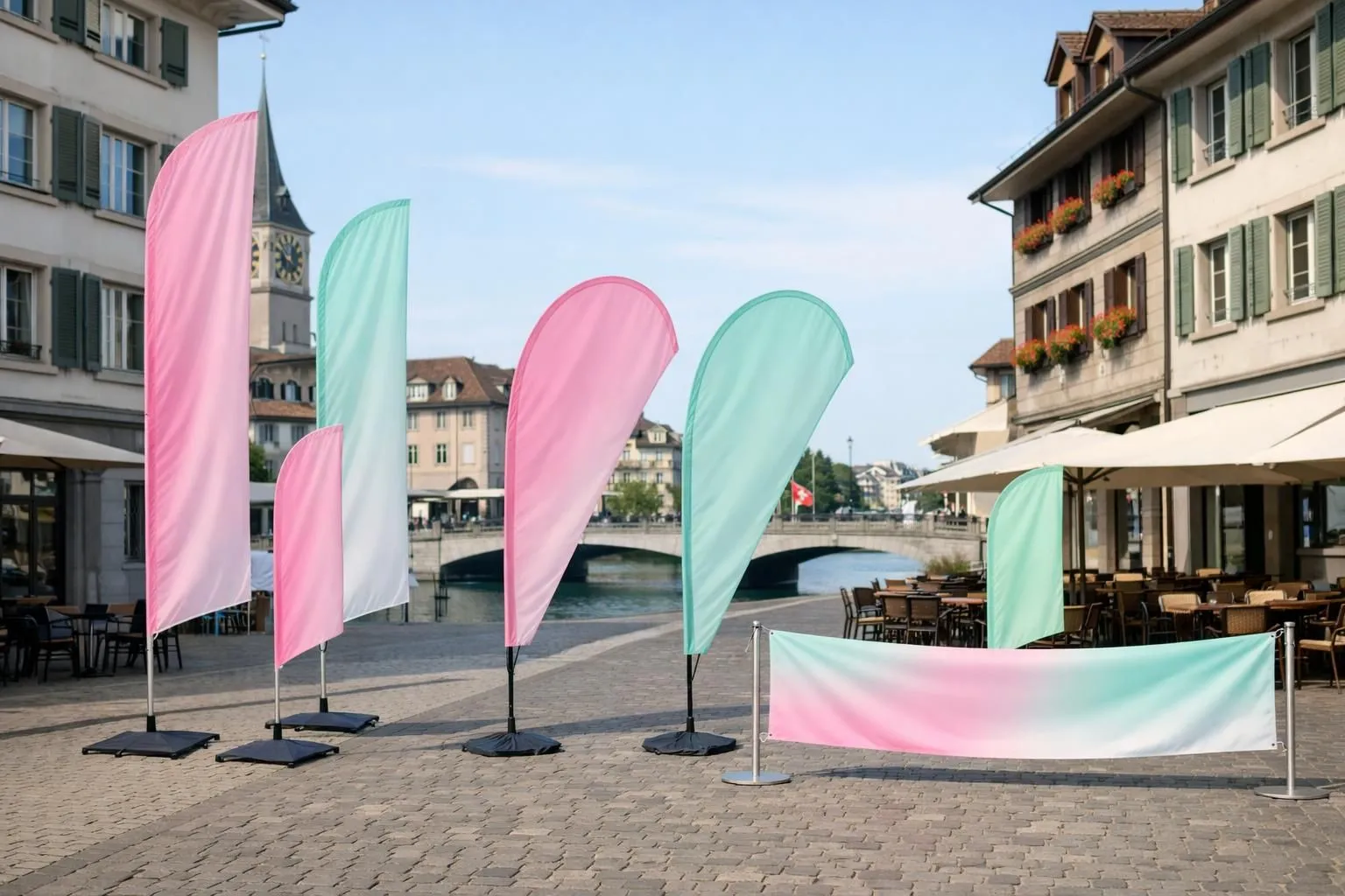 Wide variety of different promotional flag types displayed outdoors in Swiss urban setting, showing vertical oriflammes in various heights, teardrop beach flags, rectangular windbanners and horizontal flags on poles, arranged in a commercial street environment with Swiss architecture visible in background, realistic photography, professional lighting, no text or logos visible