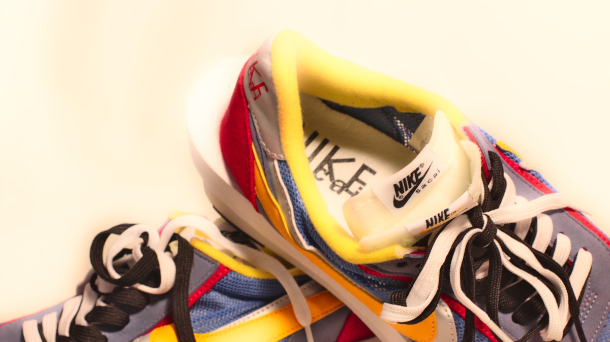A pair of colorful sneakers with white and yellow laces