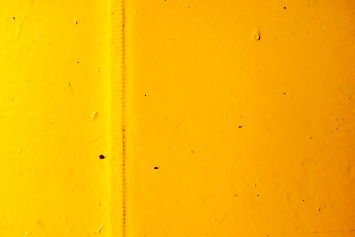 yellow painted wall with hole