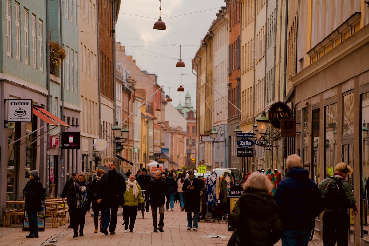 People stroll down a colorful city street.