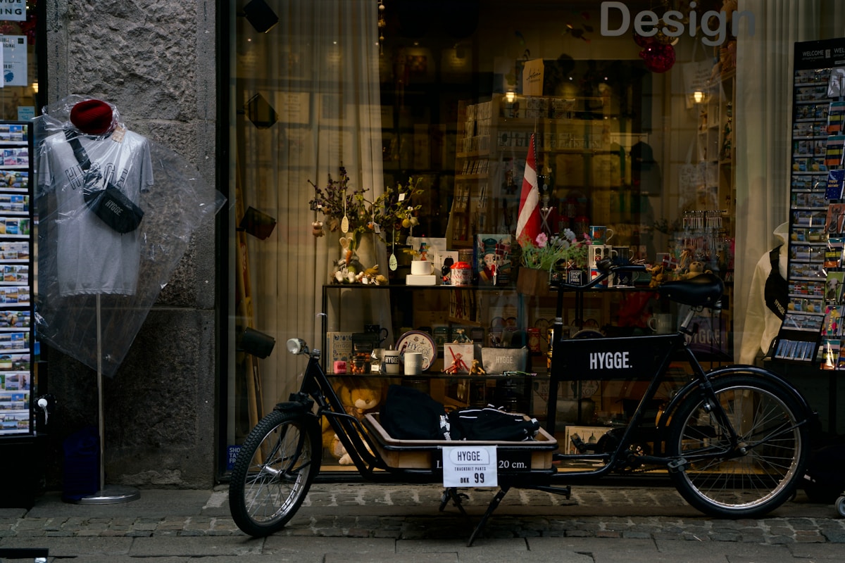 A bicycle and shop window stand next to each other.