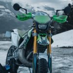 "Une moto personnalisée suisse stationnée dans la neige avec des montagnes en arrière-plan, un exemple de covering moto."
