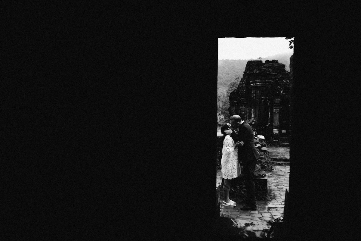 Couple kissing near ancient stone ruins