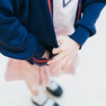 flocage uniforme scolaire personnalisé - woman tugging her blue jacket