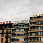 impression bâches camion genève - a tall building with a sign on top of it