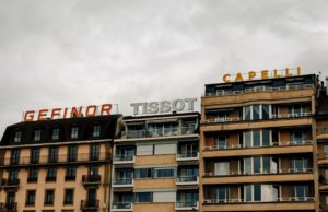 impression bâches camion genève - a tall building with a sign on top of it
